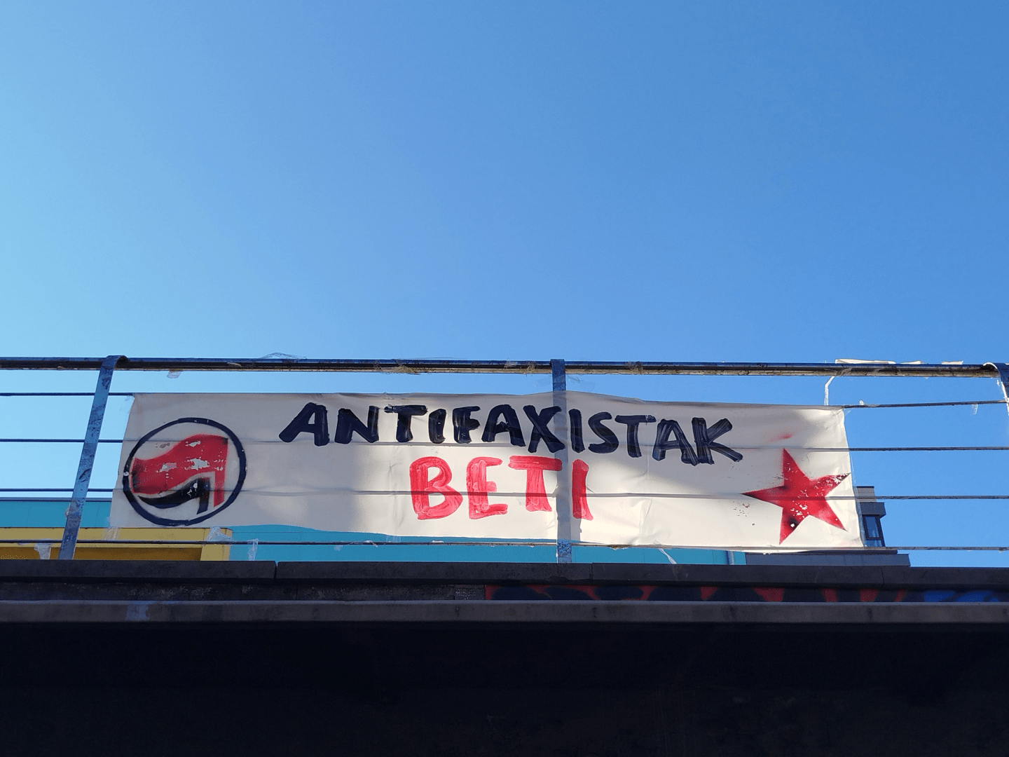 Antifaxistak beti dion pankarta izar gorriarekin eta bandera beltz eta gorriarekin.